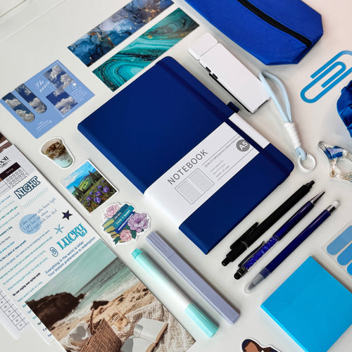 Collection of blue office supplies and stationery items on a desk.